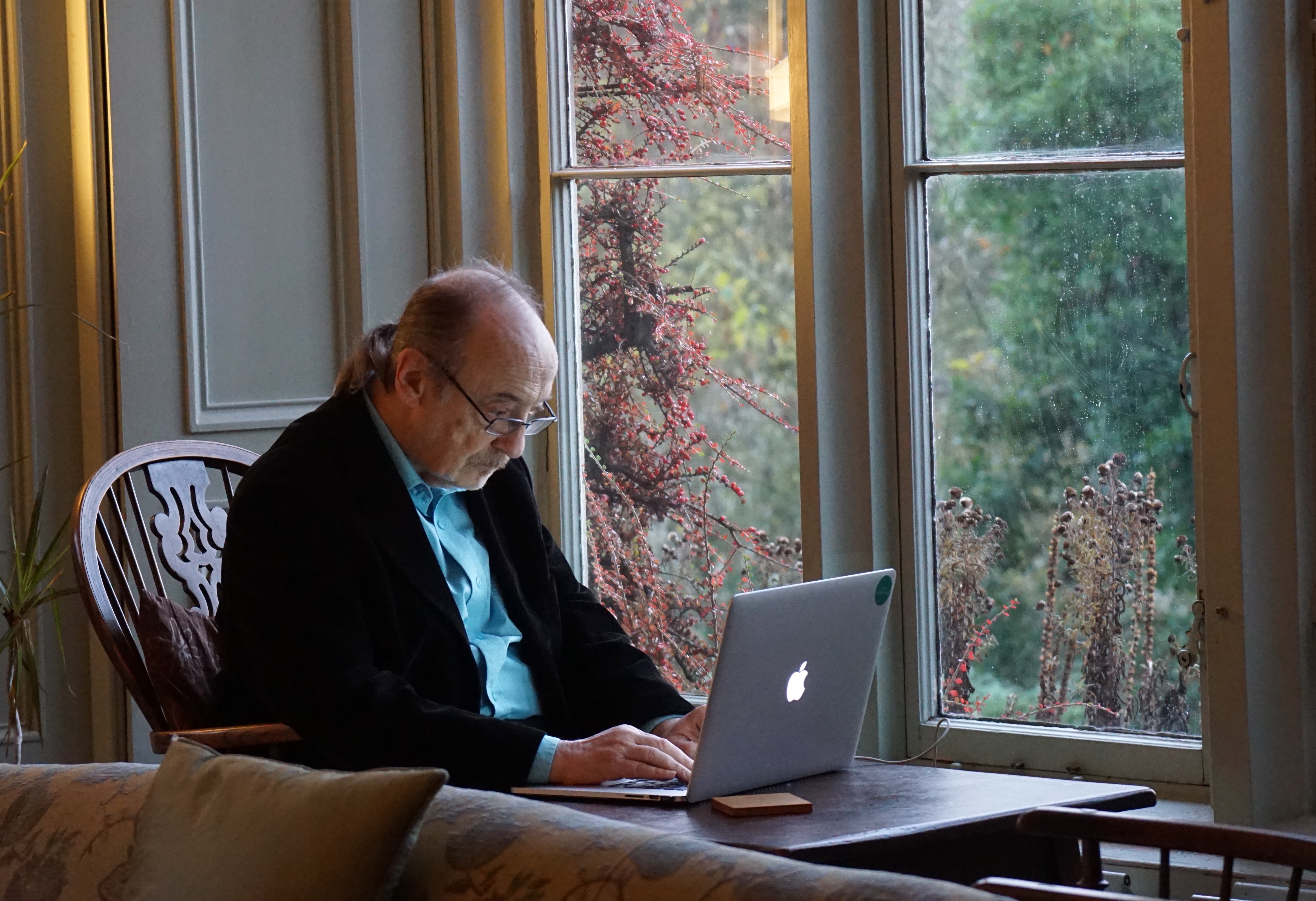 Old man looking at computer stock