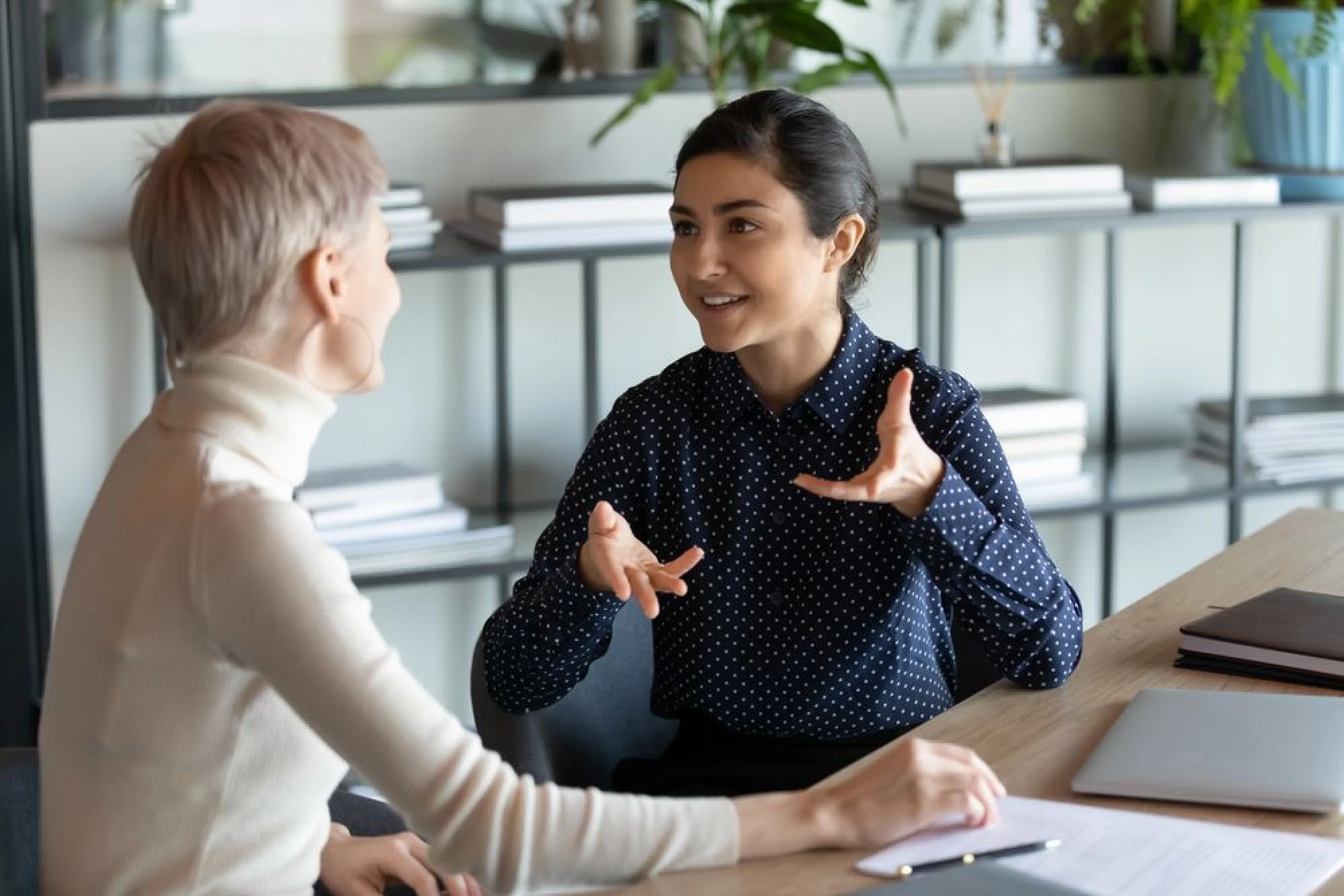 Two women discussing stock